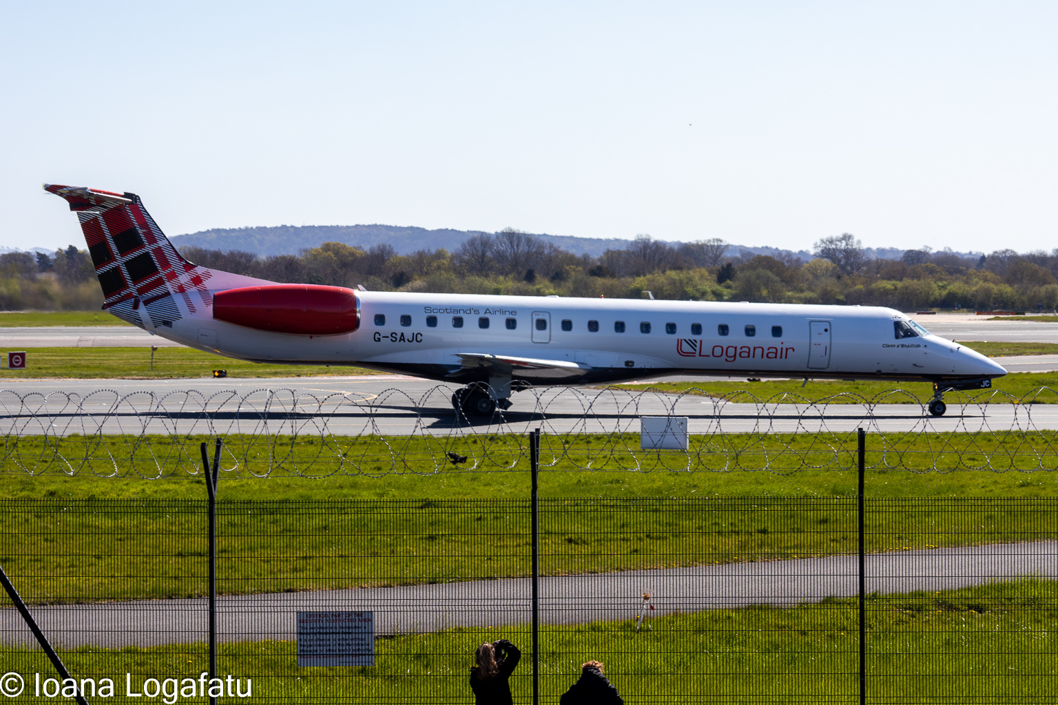 Embraer jet taxiing on a bright sunny day